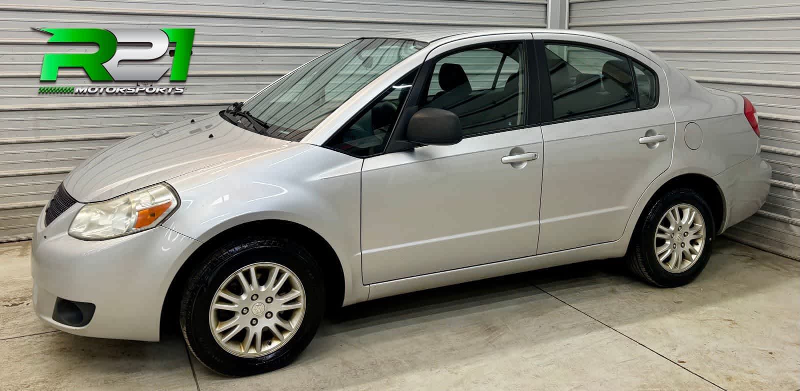 Pearl White 2013 Suzuki SX4 LE Sedan Front-Wheel Drive Manual